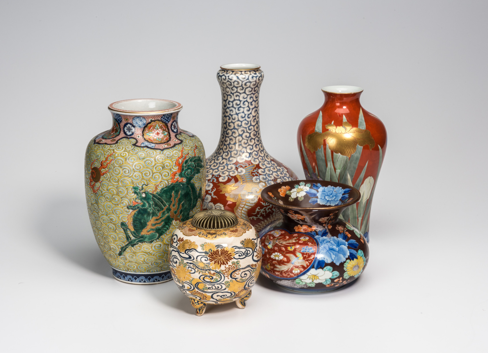 A photo of five colorfully-decorated vases in different shapes and sizes.