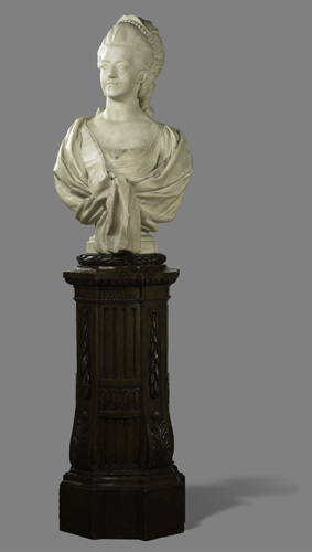 A bust of the head and shoulders of a woman wearing a shawl, with her hair held away from her face by a small crown or diadem.