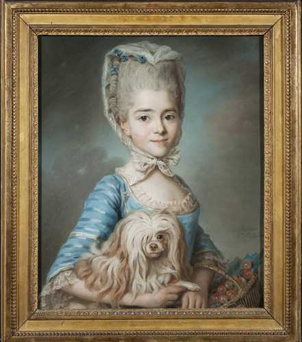 A woman with light skin and gray hair in a tall updo is wearing a blue striped dress and a hair covering that ties in a large bow beneath her chin. In her lap she holds a long-haired lap dog and a basket of fruit that may be cherries. The woman has a slight smile on her face.