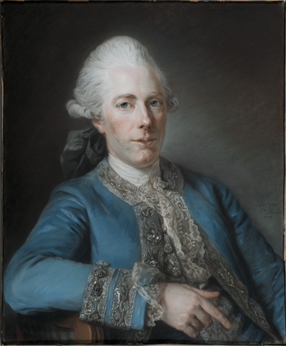 A man with light skin, pink cheeks and nose,  blue eyes, and gray hair is shown seated from the waist up. He wears a bright blue coat that has elaborate silver trim around the edges and cuffs. He is leaning against the back of the chair with one arm, the index of that hand slightly extended and pointing downward.