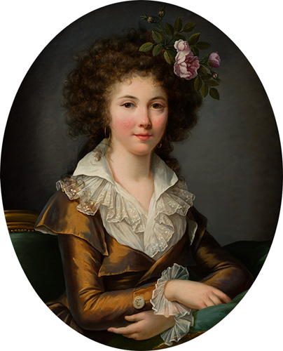 A young woman with very light skin, very pink cheeks and lips, and a large updo of curly dark brown hair is shown from the waist up. She wears a dark orange-colored dress with long sleeves and a white ruffled neckline and wrists, as well as flowers that may be roses in her hair.