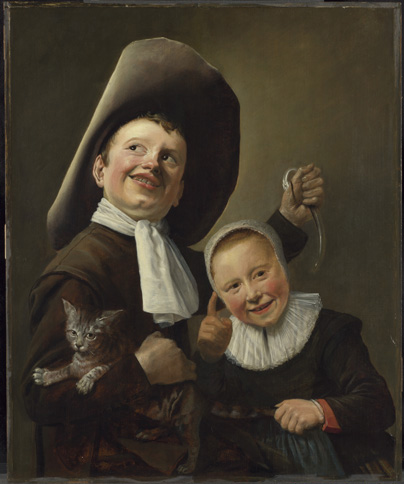 Two children, both with light skin and very pink cheeks, dressed in dark clothing, stand close together. The boy on the left wears a very large hat folded up on one side along with a white scarf tied around his neck, and he looks up and away to his right. In one hand he holds an eel, while in the other arm he is holding a small cat to his torso. Net to him, a smaller girl wears a dark dress with a large white ruffle collar and a close-fitting white cap that covers all of her hair. She is holding up one hand with the index finger raised as she looks at someone away outside the scene, and with the other hand she is holding the end of the cat's tail.