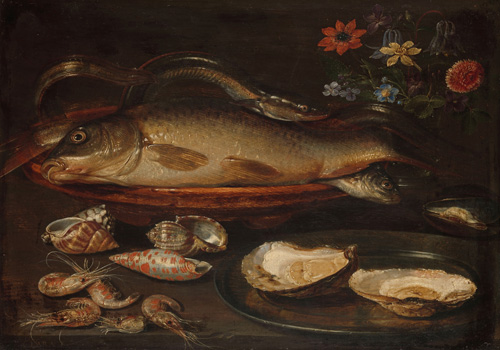 A plate with one large shrimp and one small shrimp sits on a table. In front of this plate, several seashells, five shrimps, and two oysters on a silver platter also sit on the table.