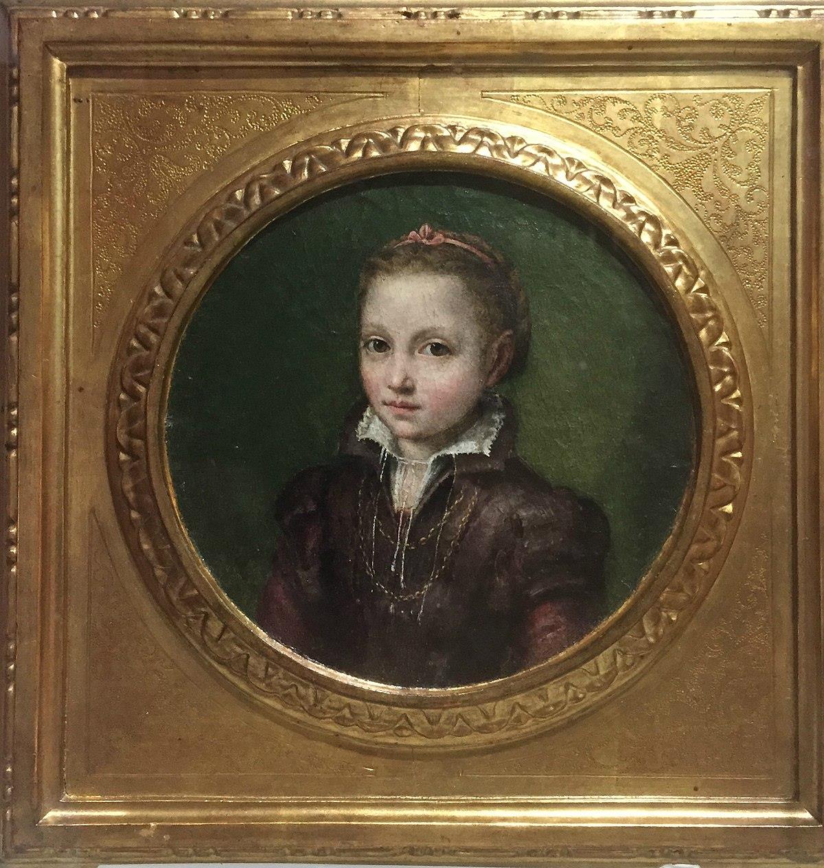 A round portrait of a young girl, maybe eleven or twelve years old, in a gold frame. The background of the portrait is green, and the girl is wearing sixteenth-century clothing, with a white collar and a pink bow in her hair. She looks directly out at the viewer.