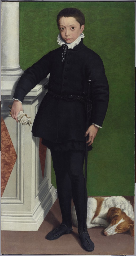 A full-length portrait of a boy standing at a column, with his elbow resting on it. A dog sleeps at his feet. He is wearing all black with white lace accents at his collar and sleeves and he looks out directly at the viewer. His left hand rests on the sword attached to his hip.