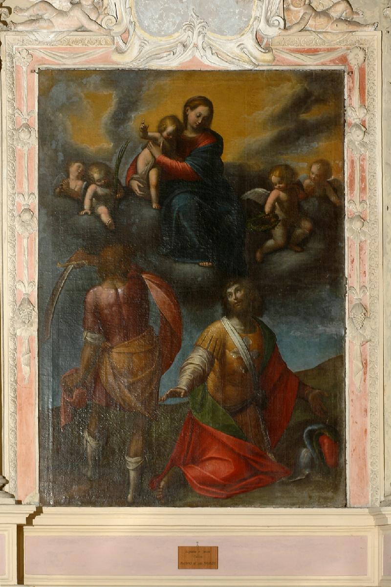 St. Maurizio appears on his knees at the bottom right corner of the canvas, looking up at a man whose back is turned and who is poised to strike him with a sword. Above the two pictures, the Virgin Mary is seated in the clouds holding the infant Jesus and looking down at his martyrdom. She is surrounded by four other putti.