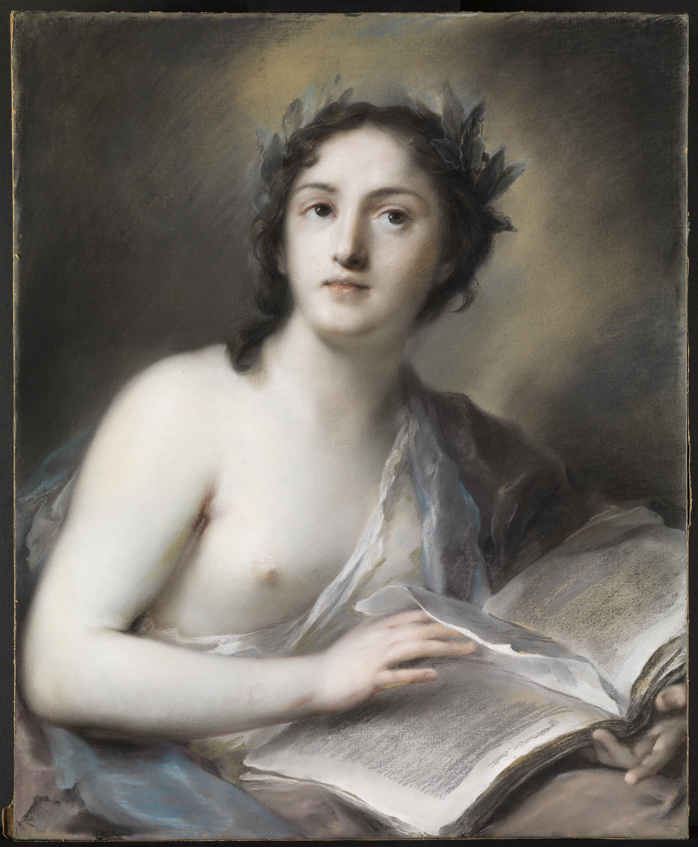 A classicized portrait of a young woman, cropped at half-length, seated in front of a dreamy, cloud-like background. She holds a book in her lap and looks up towards the sky. She wears a laurel crown and diaphanous grown, with one breast bared.