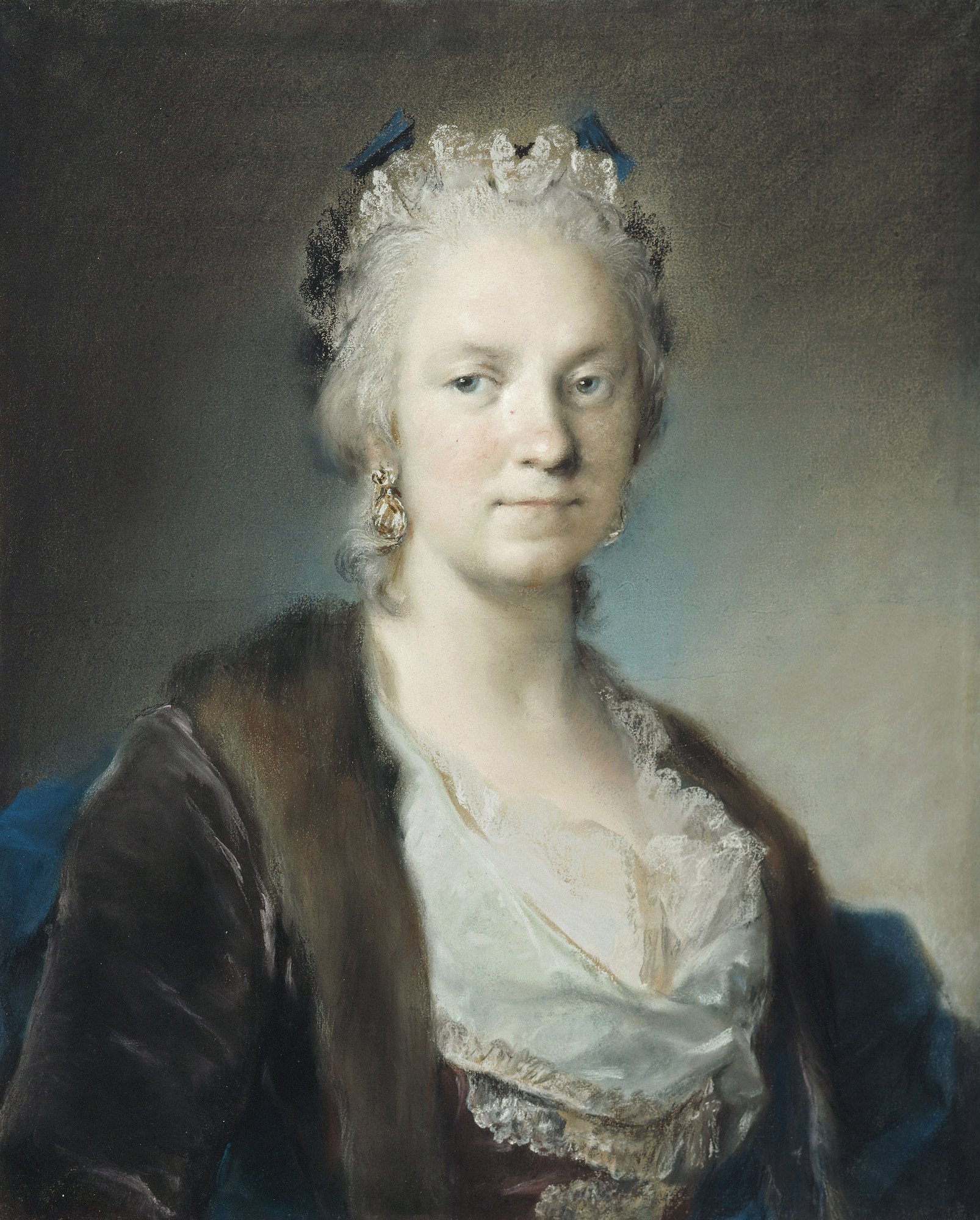 A bust-length portrait of the artist as a middle-aged woman, seated in front of a gray background. She is elegantly dressed in eighteenth-century clothing, including a coat trimmed with fur, large earrings, and bows in her hair. She looks out, away from the viewer, with a slight smile.