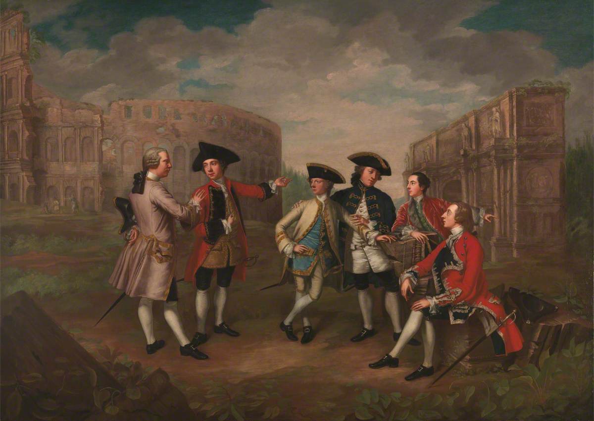 Six men in eighteenth-century clothing are gathered in a group, with just one sitting and the others standing. They are engaged in two groups of conversation with all of the men gesturing to one another. The background includes Roman ruins and a blue sky with clouds.