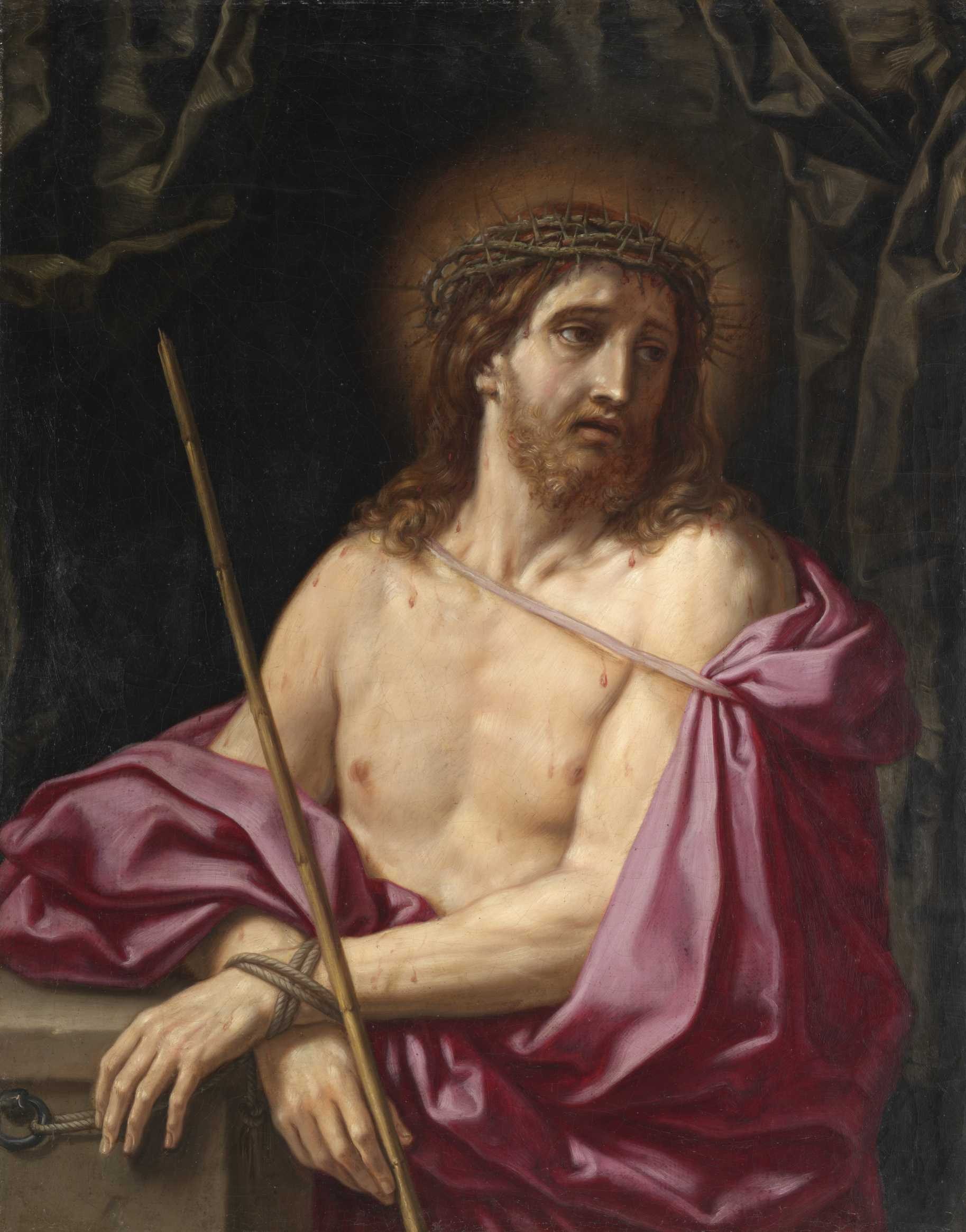 An image of Christ with his wrists bound and crossed in front of him, wearing a crown of thorns. He holds a spear in one hand and looks off to the right with an anguished expression. He has a beard and brown curls that fall to his shoulder, with a faint halo behind his head. He wears a mauve, satin cloth draped around his otherwise nude body.