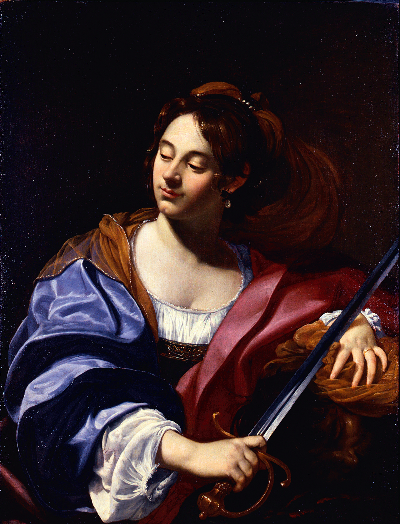 A half-length portrait of a young woman wearing an elaborate costume of satin white, blue, mauve, and orange. Her hair is tied back, and she wears earrings. She holds a sword in her right hand, crossed across her chest. She looks down and to the left of the canvas with a serene smile, seemingly unaware of the viewer.