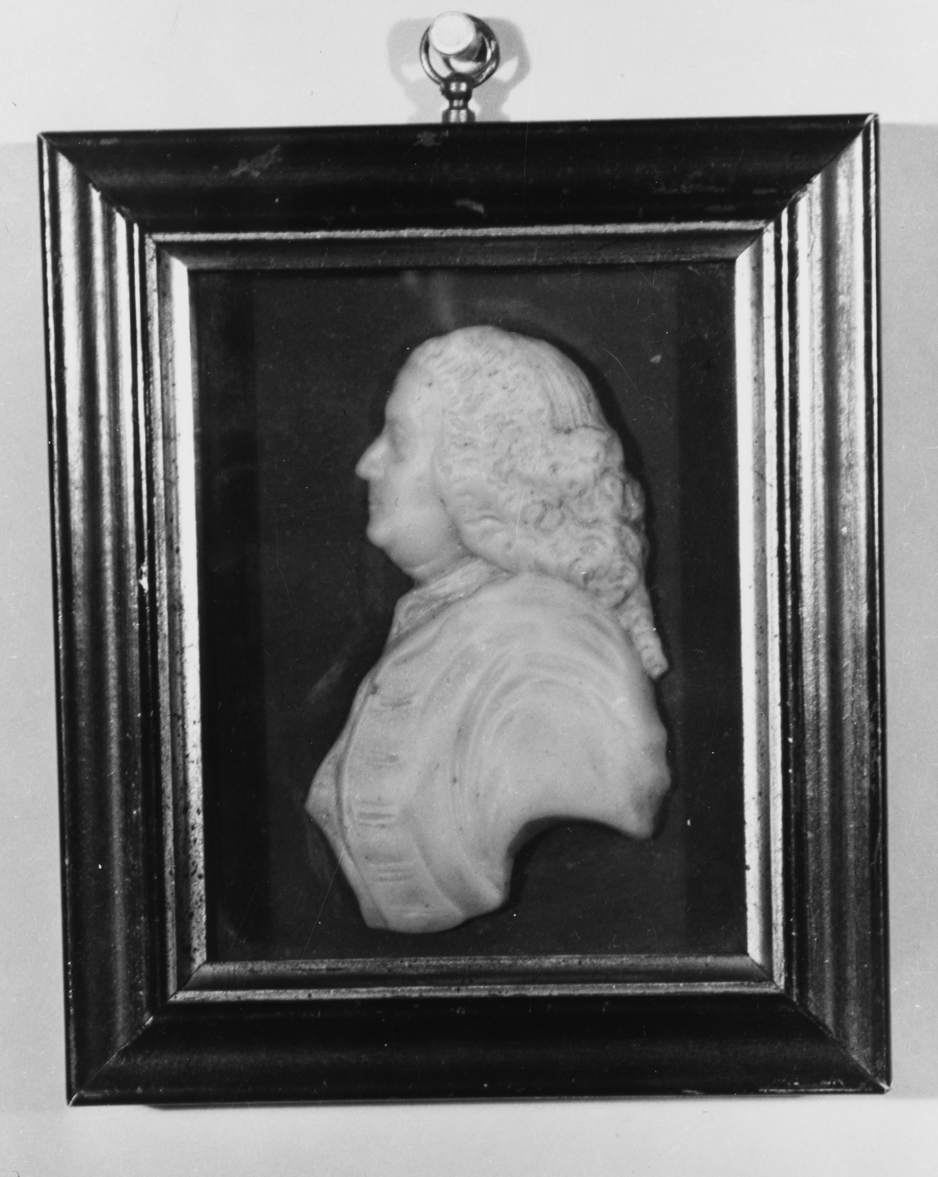 A bust-length portrait of a man in profile, modeled in relief with wax. The man looks to the left and wears a coat and an elaborate eighteenth-century wig. He appears to be middle aged.